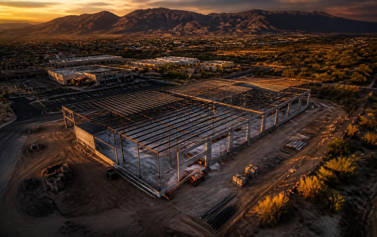 Aerial view of a commercial building under construction outside Tucson at golden hour